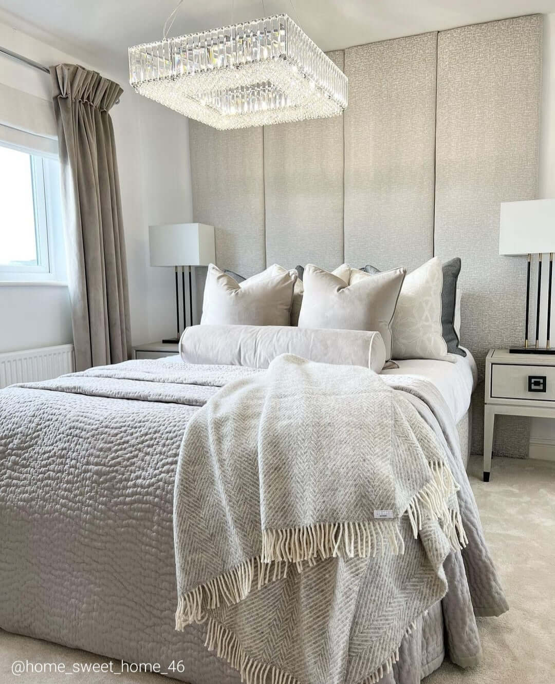 Salzburg large square chandelier in polished chrome with crystal glass blocks and buttons, styled in a luxury modern bedroom.