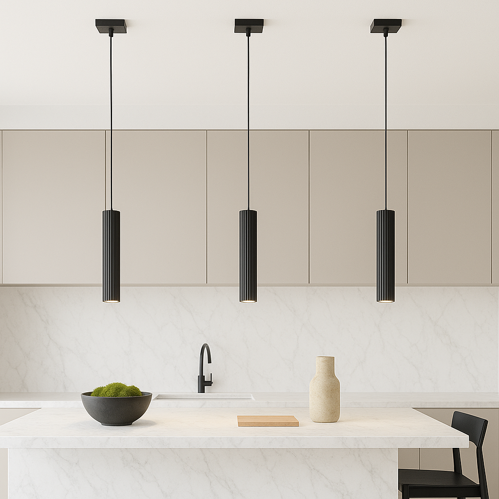 Black cylinder pendant lights over white marble island